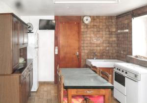 a small kitchen with a table and a sink at Studio convivial à Gérardmer, 35 m² avec vue sur la montagne in Gérardmer