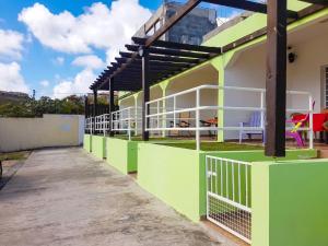 a building with green and white paint on it at Charming Apartment in La Savane - 65 m² - Terrace with View in Happy Bay +4 photos