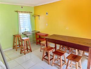 a room with a wooden table and some stools at Lago Resort - Kakamega Forest in Kakamega