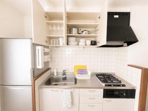 a kitchen with a sink and a refrigerator at 美瑛Stay in Biei +19 photos