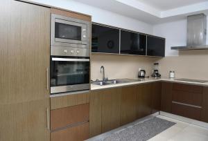 a kitchen with wooden cabinets and stainless steel appliances at "Spacious villa in Caniçada with year-round private pool" in Caniçada