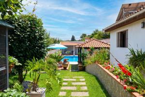 a garden with a swimming pool and a house at Spacious Villa with Private Pool in Oliveira de Azeméis in Oliveira de Azemeis