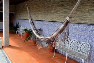 a hammock hanging from a wall on a patio at Spacious Villa with Private Pool in Oliveira de Azeméis in Oliveira de Azemeis +28 photos