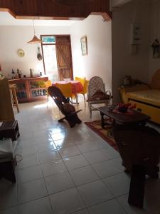 a living room with a table and chairs at Appartement spacieux à Sainte-Rose - 120 m² - Terrasse ensoleillée in Sainte-Rose