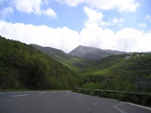 an empty road with mountains in the background at Appartement spacieux à Sainte-Rose - 120 m² - Terrasse ensoleillée in Sainte-Rose +4 photos