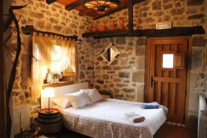 a bedroom with a bed in a stone wall at Charming House in La Cavada with Jacuzzi in La Cavada
