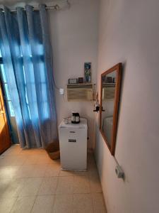 a bathroom with a small refrigerator and a mirror at Dar Essadeg Bis in Tataouine +8 photos