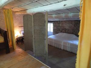 a bedroom with a bed and a large mirror at Appartement raffiné à Feliceto - 120 m² avec vue sur montagne in Feliceto