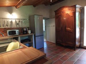 a kitchen with a refrigerator and a counter top at Appartement raffiné à Feliceto - 120 m² avec vue sur montagne in Feliceto
