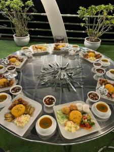 a table with many different dishes of food on it at SunWay hotel in Cat Ba