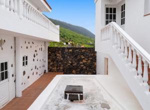 a view of the courtyard of a house with a staircase at Modern apartment in Frontera, 45 m² with sea view balcony in Frontera