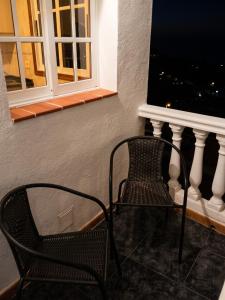 two chairs sitting in front of a window at Modern apartment in Frontera, 45 m² with sea view balcony in Frontera