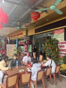 a group of people sitting at a table in a restaurant at SunWay hotel in Cat Ba +22 photos