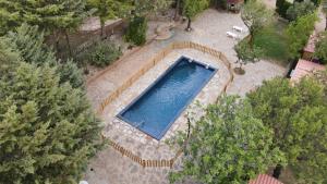 an overhead view of a swimming pool with trees at Camping Castillo de Loarre in Loarre