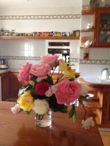 a vase of flowers on a table in a kitchen at Seaside villa in Jávea with private pool in Jávea +17 photos