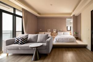 a living room with a bed and a couch at Yuan Lu Homestay in Lukang