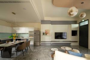 a kitchen with a table and chairs and a refrigerator at Yuan Lu Homestay in Lukang