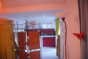 a living room with a floor lamp and a kitchen at Studio avec vue sur la mer à Fort-de-France 50 m² exceptionnel ! in Fort-de-France