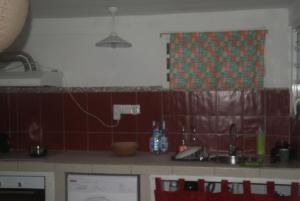 a kitchen with red tiled walls and a sink at Studio avec vue sur la mer à Fort-de-France 50 m² exceptionnel ! in Fort-de-France +10 photos