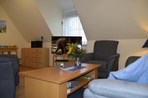 a living room with a couch and a coffee table at Waack, Brigitte App Nr 7 in Schönberger Strand