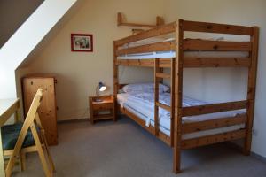 a bedroom with two bunk beds and a desk at Waack, Brigitte App Nr 7 in Schönberger Strand +11 photos