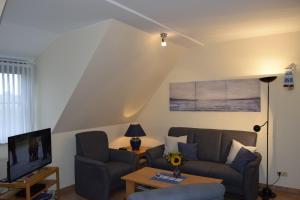 a living room with a couch and a tv at Waack, Brigitte App Nr 7 in Schönberger Strand