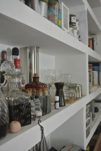 a shelf with glass jars and other items on it at Picturesque Villa in Santo António das Areias with Private Pool in Marvão +31 photos