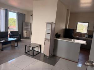 a living room with a counter and a table at Panatina Sunset Residence in Honiara
