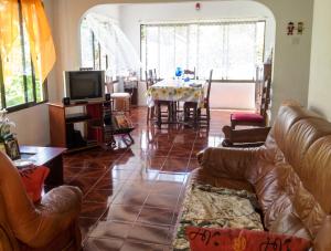a living room with a couch and a dining room at Charming house in Victoria with mountain view in Victoria