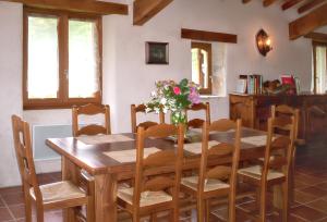 a dining room with a wooden table and chairs at Maison charmante à Saint-Cirq avec piscine privée in Saint-Cirq