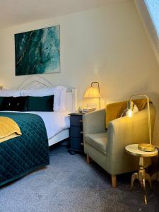 a hotel room with a bed and a chair at The Wadham in Weymouth