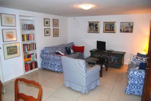 a living room with a couch and a chair and a desk at Spacious house in Lukoran with sea view in Lukoran