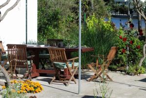 a wooden table and chairs in a garden at Spacious house in Lukoran with sea view in Lukoran