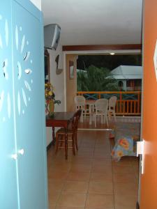 a kitchen and dining room with a table and chairs at Studio charmant à Sainte-Anne de 25 m² avec terrasse et jardin. in Sainte-Anne +64 photos