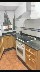 a kitchen with a stove and a counter top at Charming Apartment in Albuñol, 90 m², Near Amenities in Albuñol