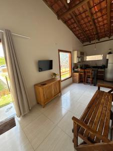 a living room with a flat screen tv and a couch at Vista do Luar Corumbau in Prado