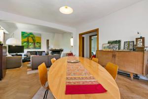 a dining room with a table and a living room at Chalet spacieux à Wangenbourg-Engenthal avec vue panoramique in Wangenbourg