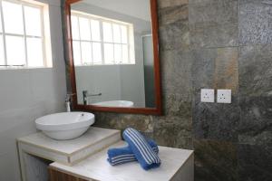 a bathroom with a sink and a mirror at Charming Studio in Blue Bay, 22 m², Near Beaches in Blue Bay