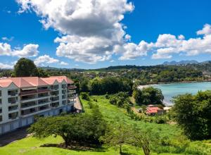 a view of a hotel with a lake in the background at Studio charmant à La Trinité - Vue mer - 40 m² in La Trinité +13 photos