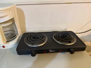 a black stove on a counter next to a microwave at MaFlo Arms in Belize City