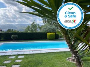 a sign that reads clean and safe next to a swimming pool at Charming Villa in Resende with Private Pool in Resende