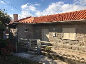 a house with a white fence next to a house at Charming Villa in Resende with Private Pool in Resende