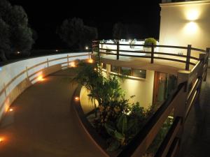 a night view of a building with a fence at Charming Apartment in Nardò with Shared Pool in Nardò