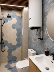 a bathroom with a toilet and a sink and a mirror at Alta Vista Apollonia Sunset in Sozopol