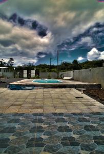 a tiled courtyard with a pool on a cloudy sky at Luxurious Villa in Pereybere with Pool in Pereybere
