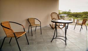 a group of chairs and a table on a balcony at Luxurious Villa in Pereybere with Pool in Pereybere +17 photos
