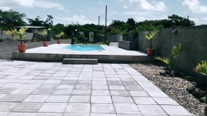 a backyard with a swimming pool and a fence at Luxurious Villa in Pereybere with Pool in Pereybere