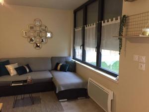 a living room with a couch and a window at Studio charmant à Abondant, 30 m² avec jardin in Abondant