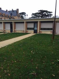 a building with a grass yard in front of it at Studio charmant à Abondant, 30 m² avec jardin in Abondant