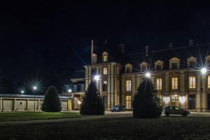 a large building with lights on it at night at Studio charmant à Abondant, 30 m² avec jardin in Abondant +10 photos